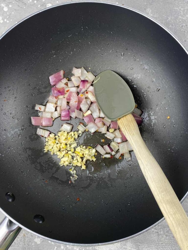 cook aromatics to make tofu green beans stir fry
