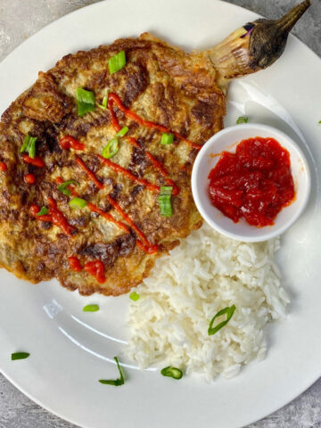 Tortang Talong serve with rice and top with banana ketchup