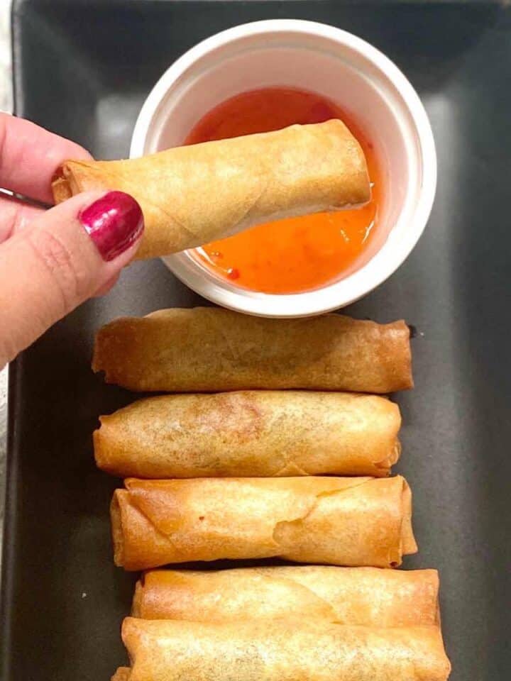 frozen spring rolls in a plate with dipping sauce