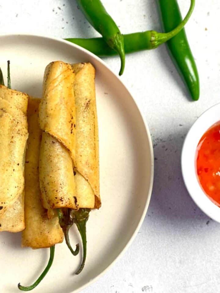 dynamite lumpia in a plate served with sweet chili sauce