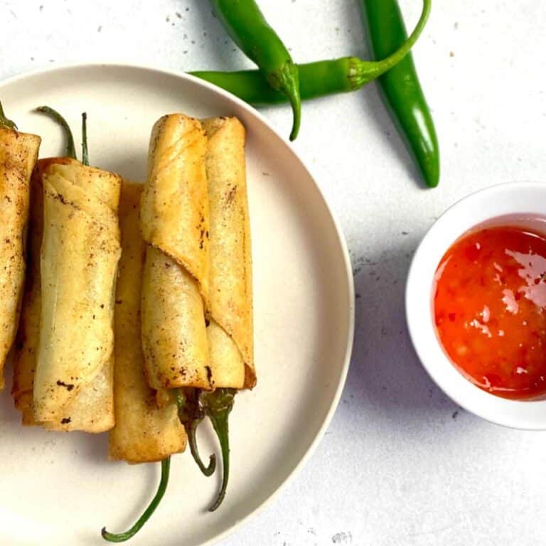 dynamite lumpia in a plate served with sweet chili sauce