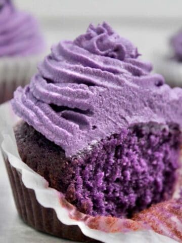 ube cupcakes with two in the background