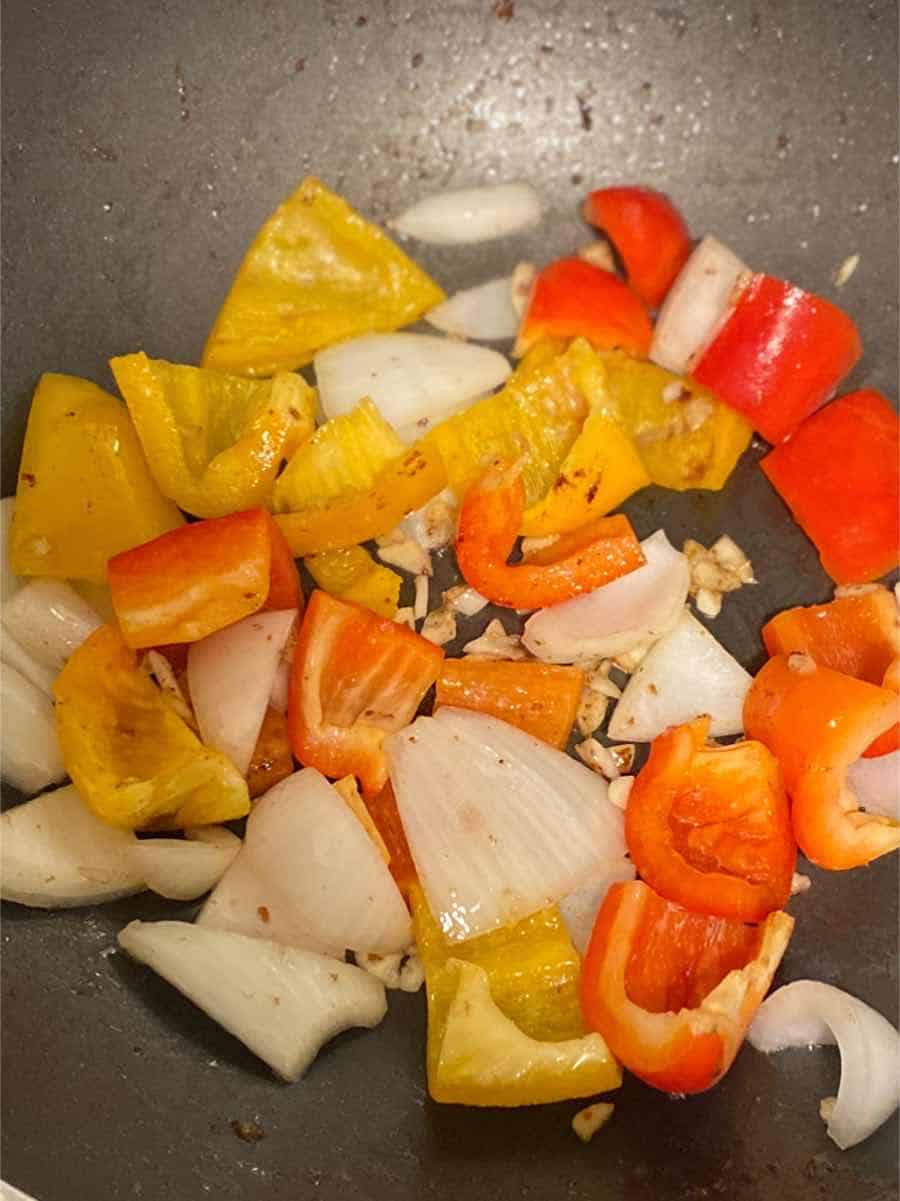bell peppers, onion in a pan