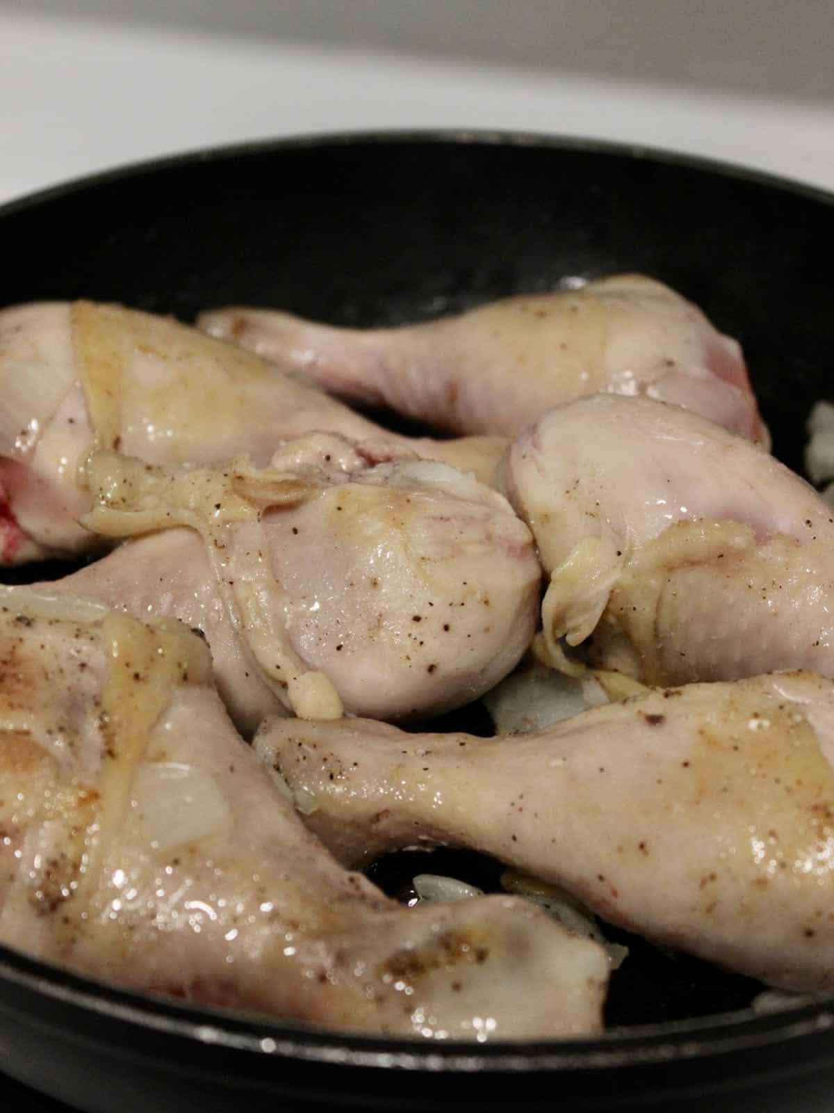 sear chicken in a pot until brown