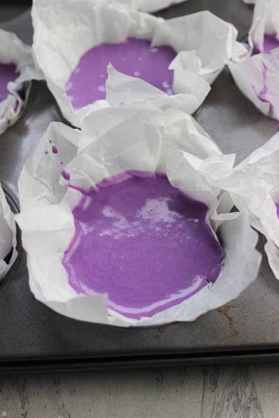 pour the ube cheesecake batter to prepared pan