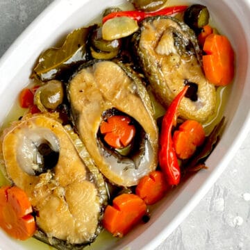 bangus slices with carrots, red peppers in white container