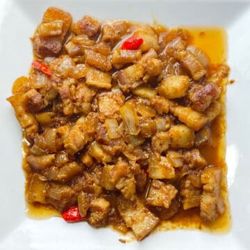 pork binagooongan sa gata in a white serving plate