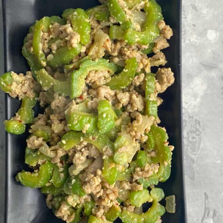 ginisang ampalaya wiht ground pork in a black serving plate