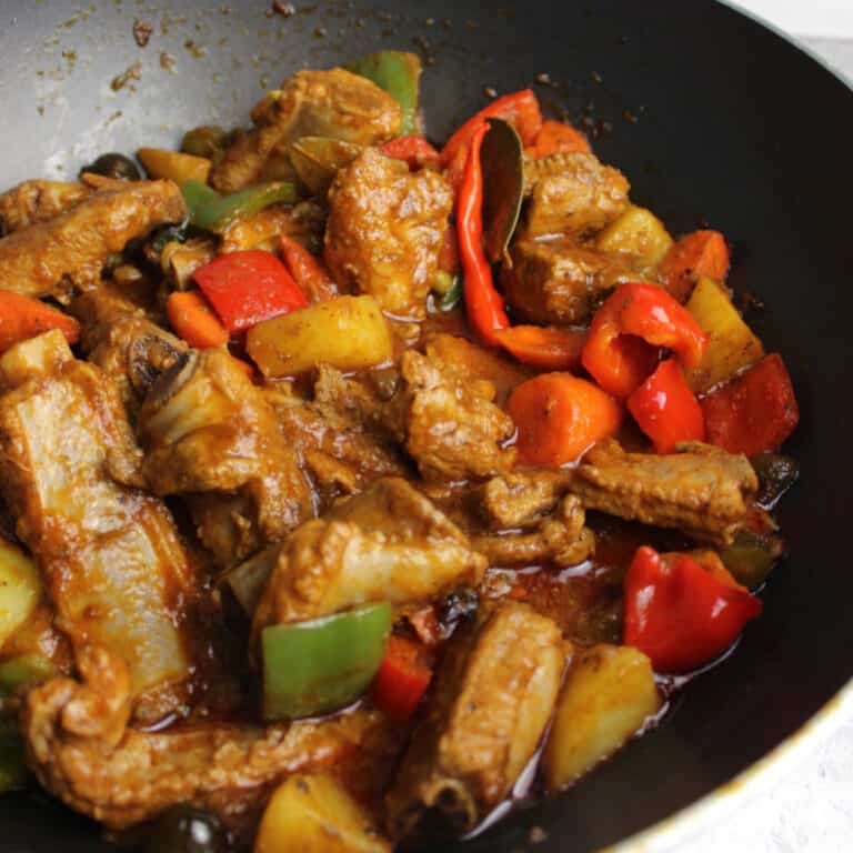 tender ribs with red bell peppers in a pot