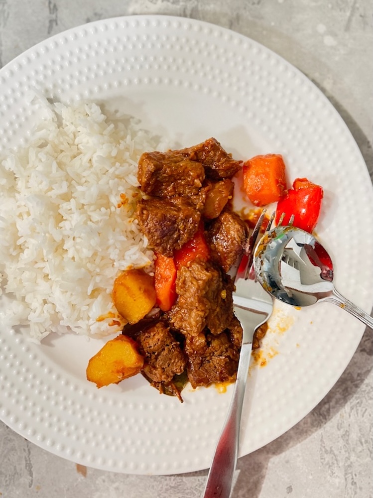 serve beef mechado wth steamed rice