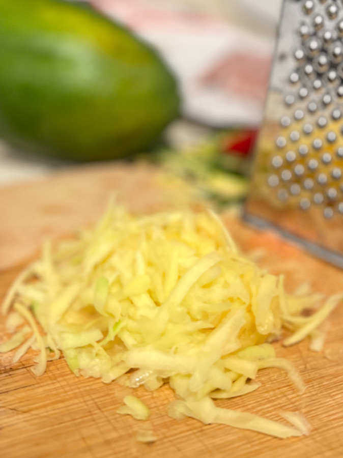 grated papaya in chopping board