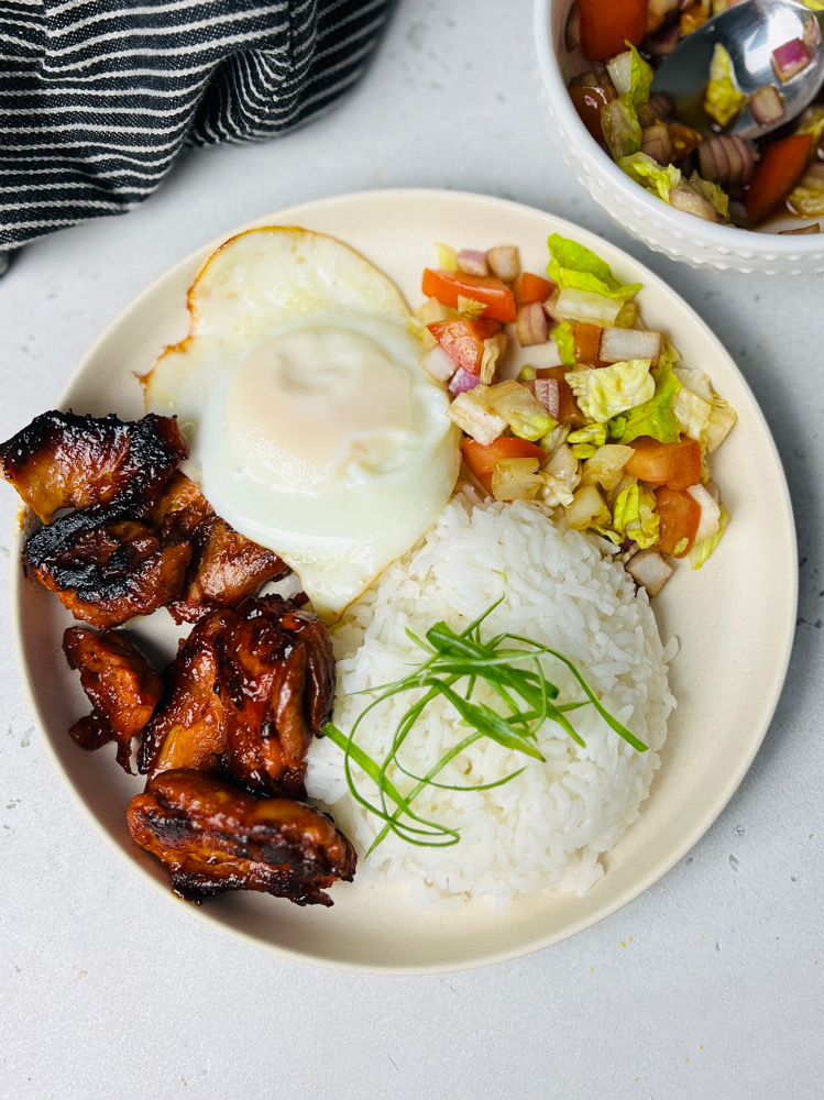 Plate with chicken tocino, egg, rice, and salad