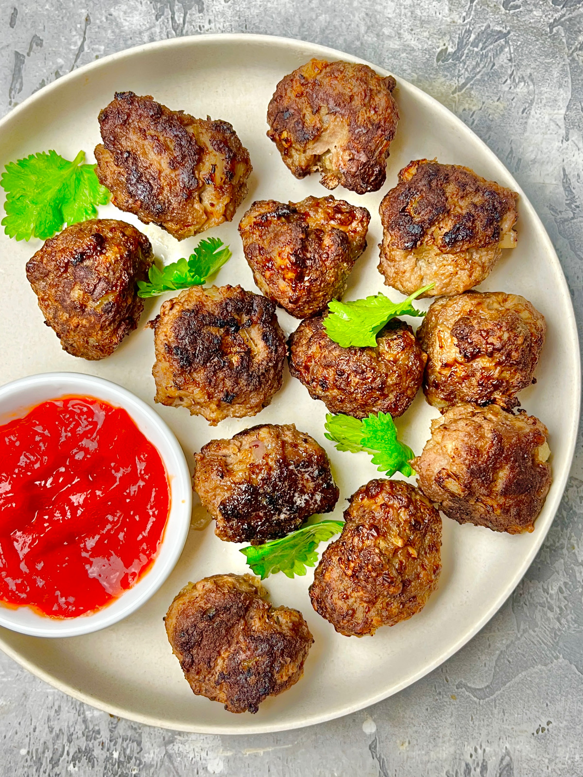 a plate with small meatballs and dipping sauce
