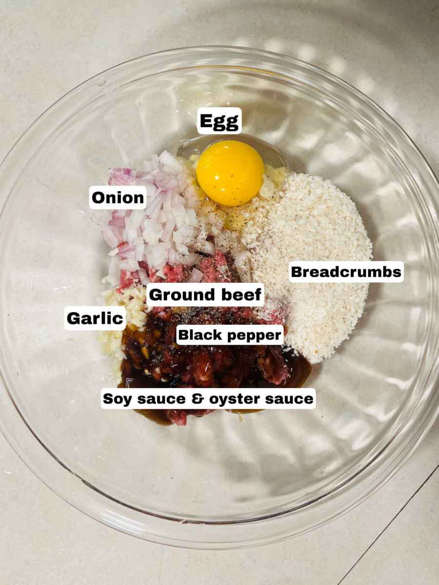 a bowl consists of ingredients like ground beef, egg, breadcrumbs and other seasonings